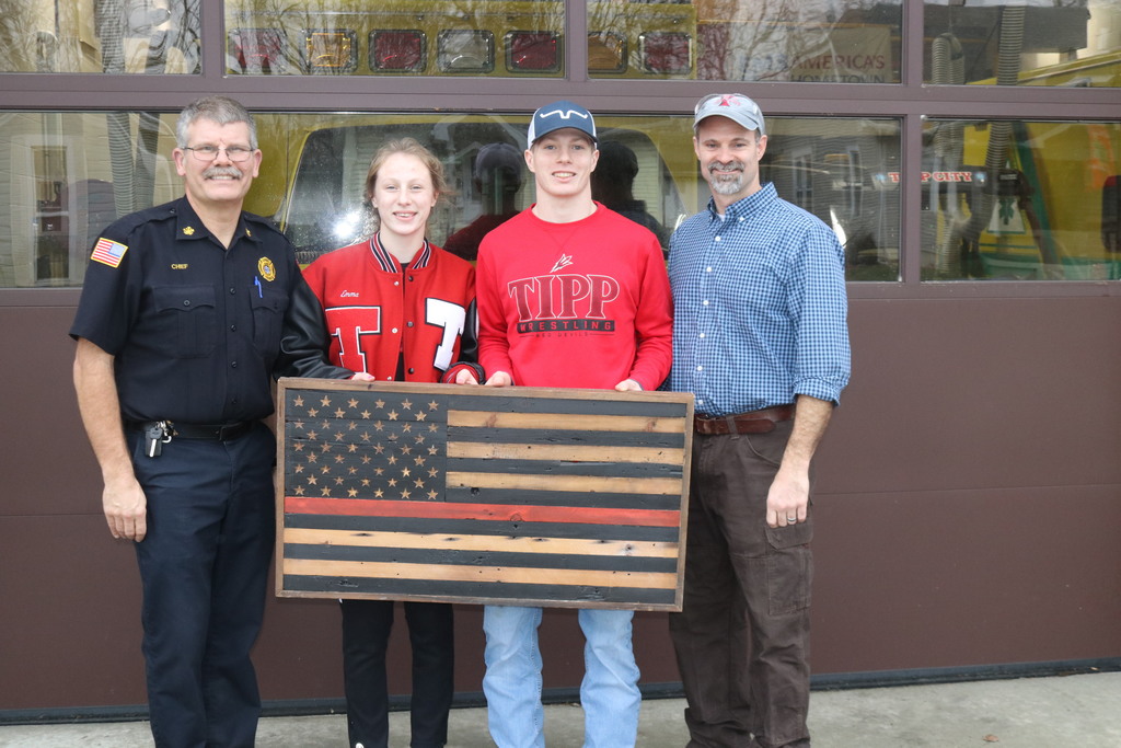Homebuilding students presenting a gift to the fire department