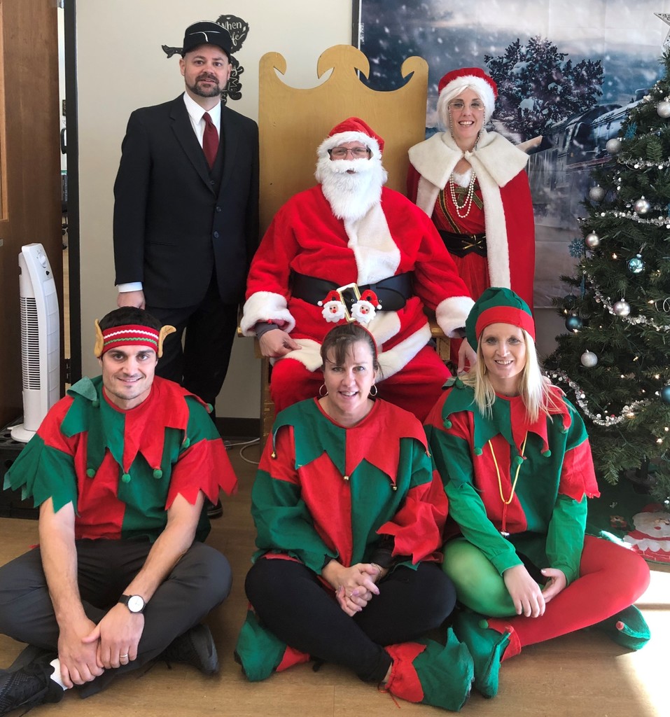 Staff members dressed as the conductor, Santa, Mrs. Claus and elves