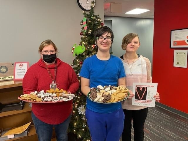 students posing with cookies