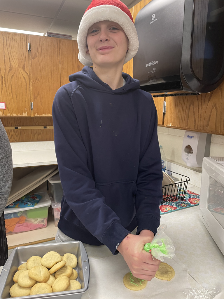 A student decorating Christmas cookies