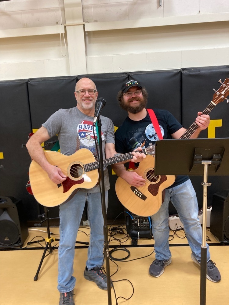 Mike and Jordan playing guitar in the lunchroom