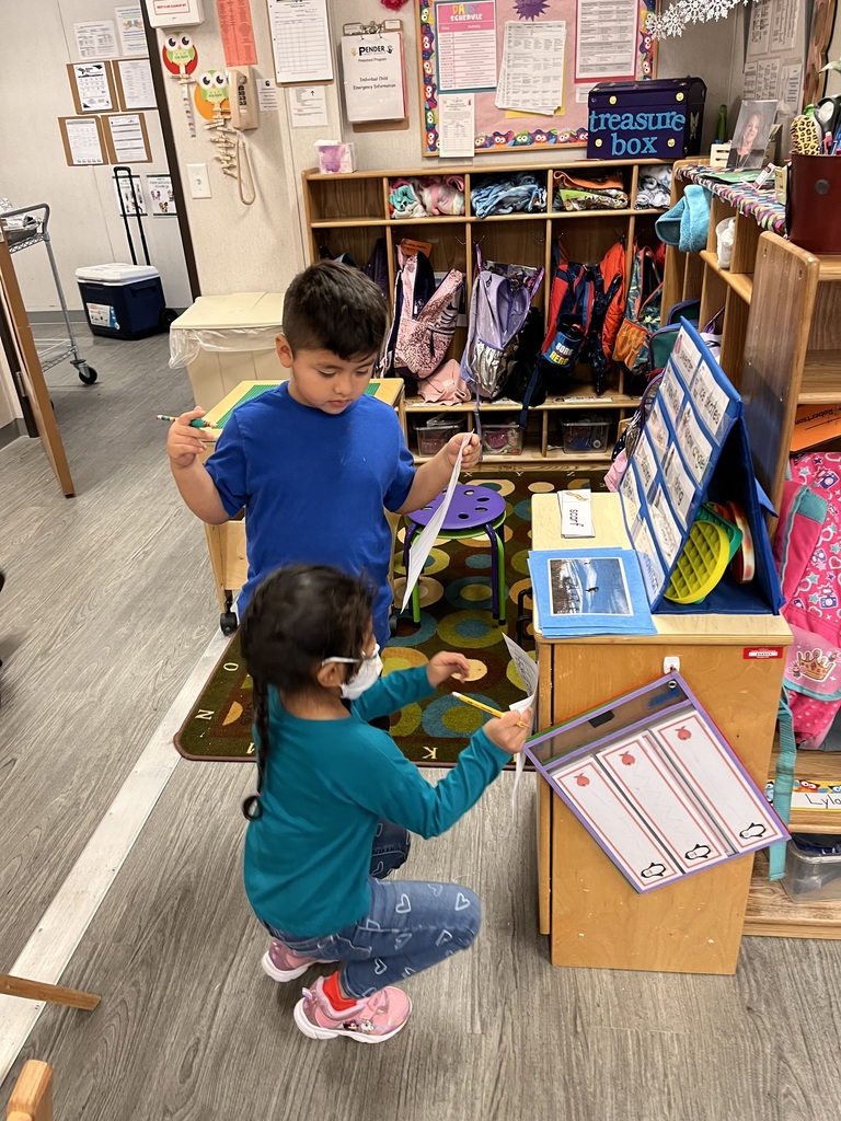 These two kids are having fun finding Winter words to write.