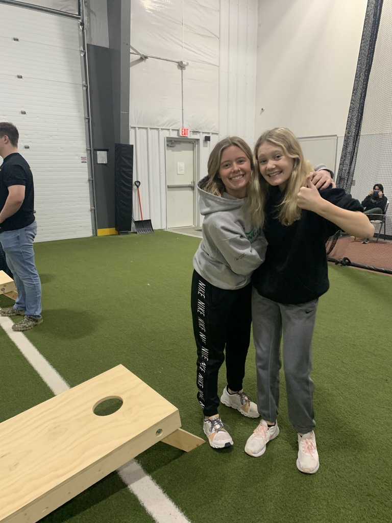Freshman girls posing while playing cornhole