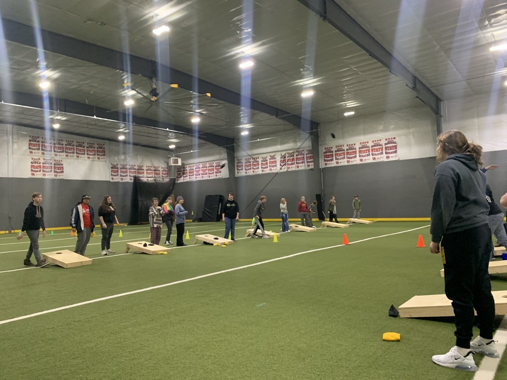Group playing cornhole