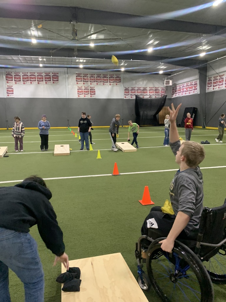 Group playing cornhole