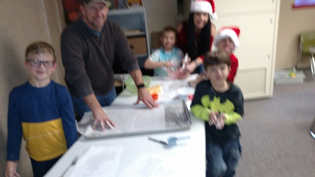 MCC 1st graders enjoy making candy cane cookies with parents and grandparents.