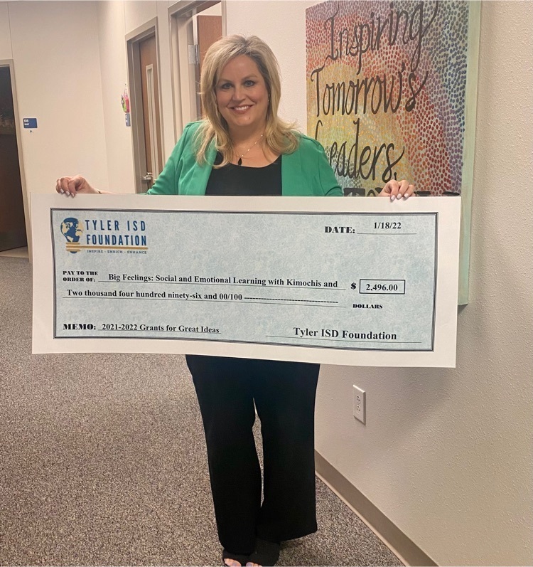 teachers posing with large check