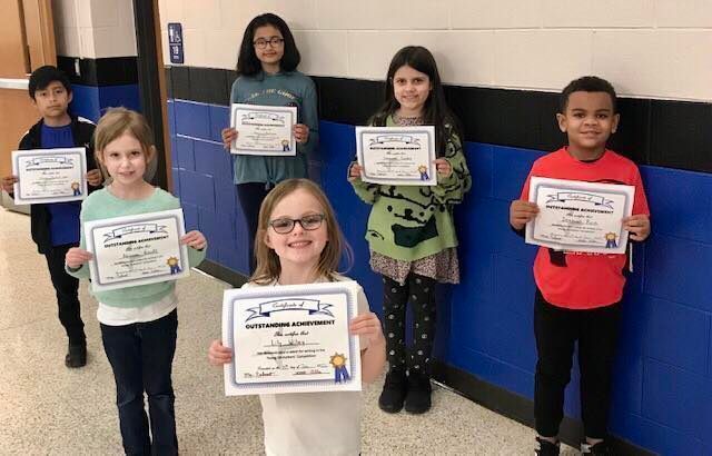 students standing together holding certificates