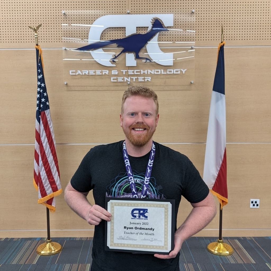 Teacher with award