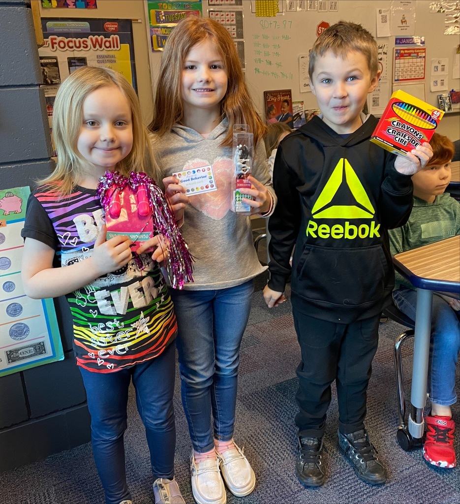 three students holding a prize