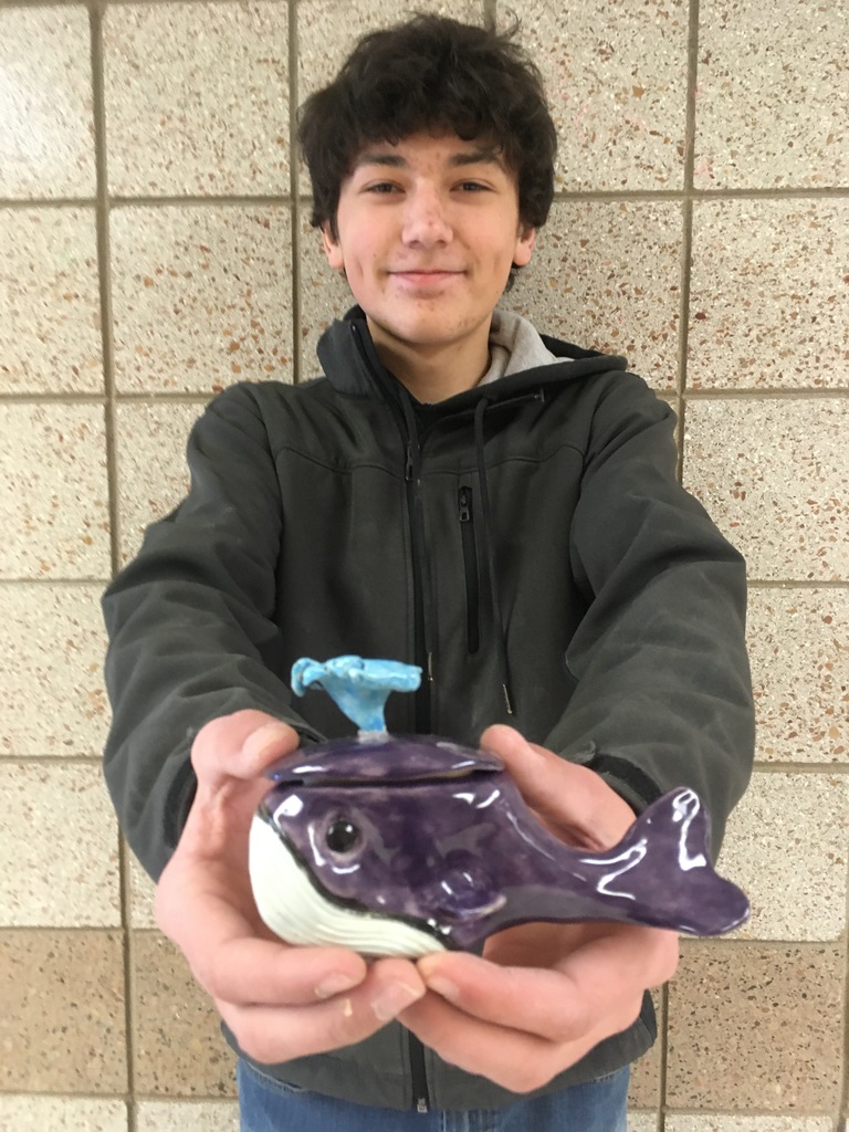 one student holding a whale