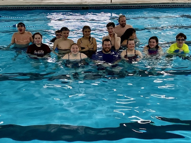 staff and students in a pool