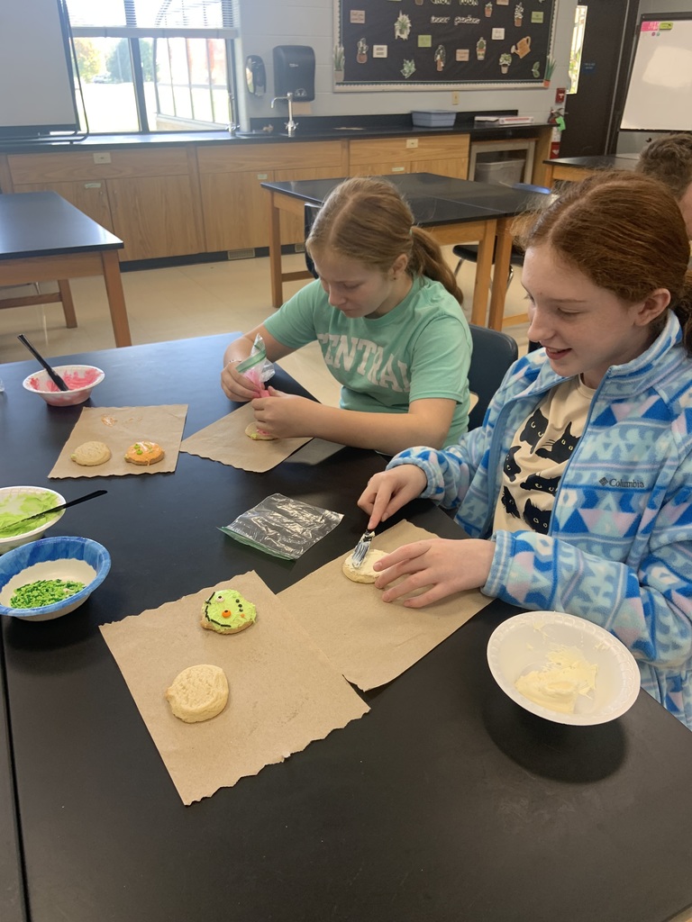 Girls frosting cookies.