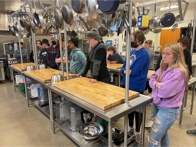culinary students observing chef demonstration