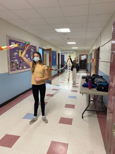 Students putting the kindness chain up in the hallway