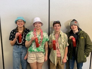 4 students holding red ribbons