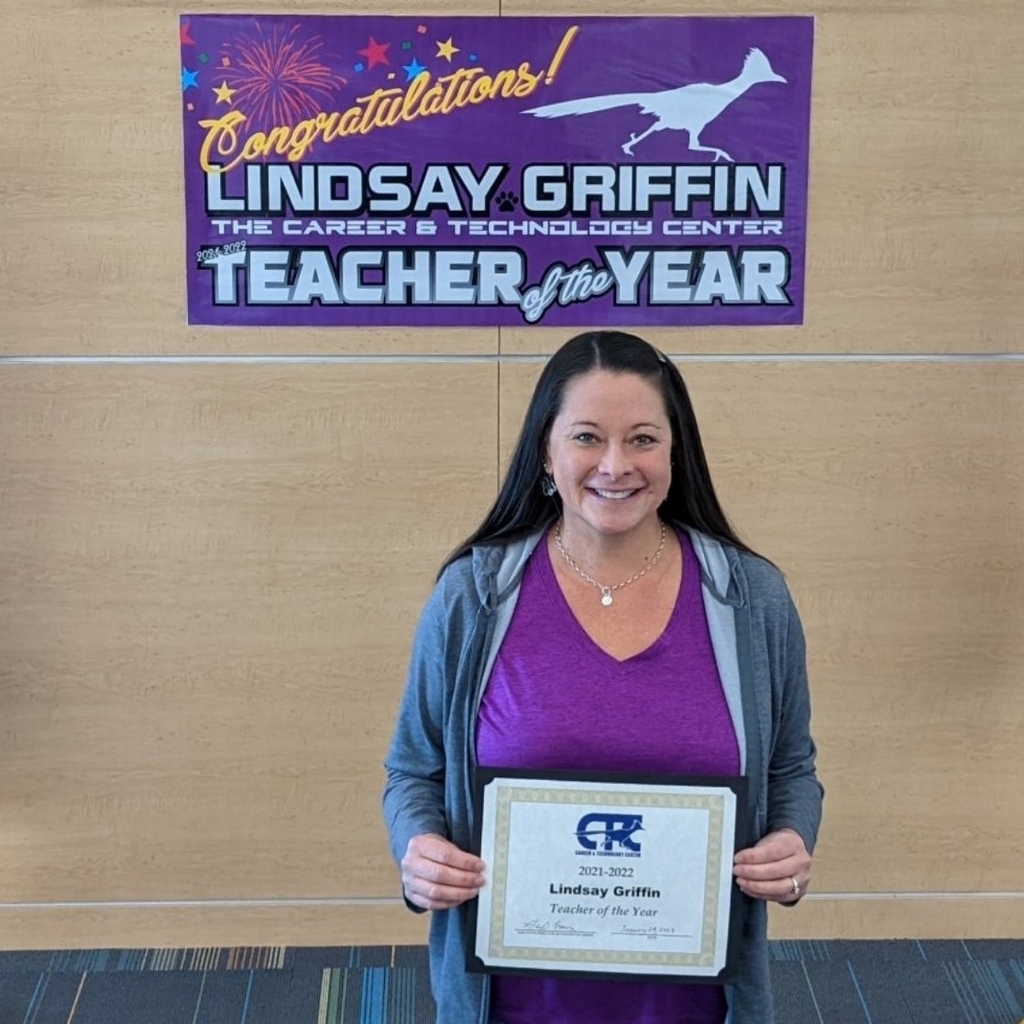 Teacher with award