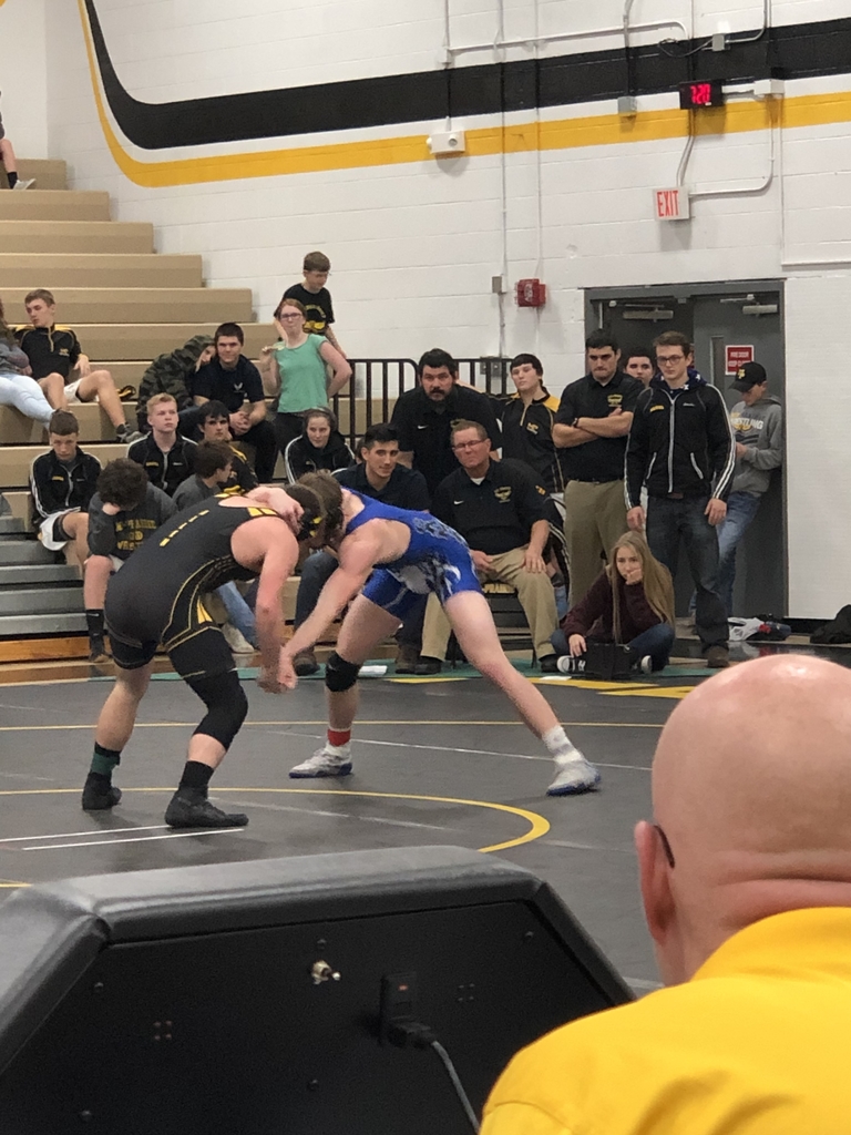 Coaches and teammates watch the tough matchup