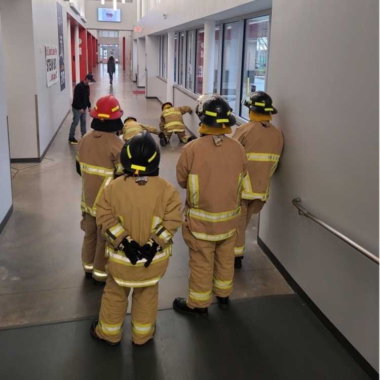 students standing in fire suits