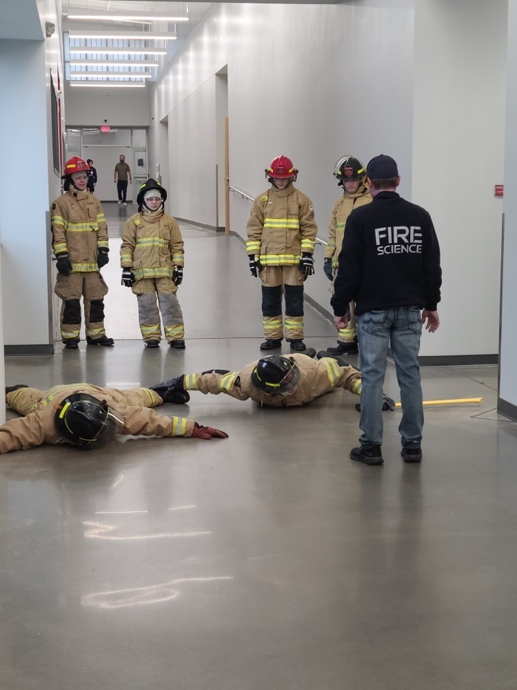 students standing in fire suits