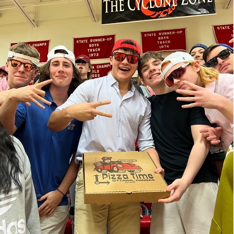 kids standing with a pizza