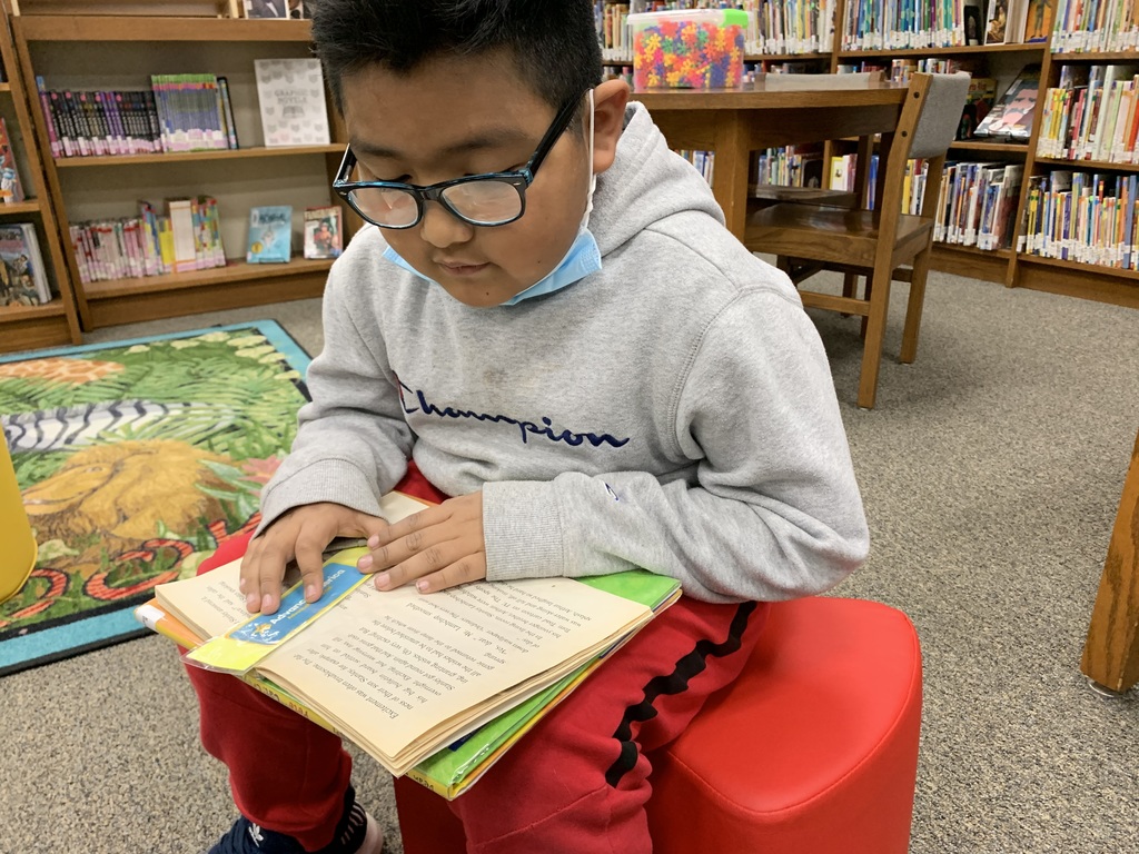 2nd graders enjoy "read to self" time after checking out their books in the library. Giving lots of ample reading time helps to grow readers!   #CPSZEBRAPRIDE