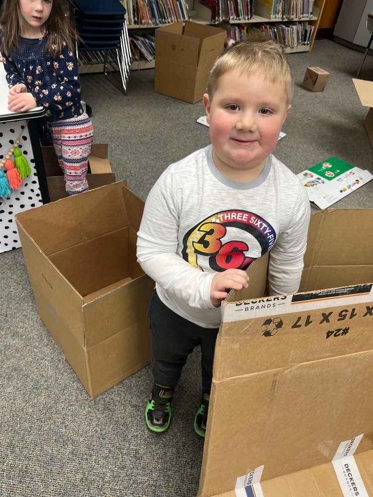 K student building with a box