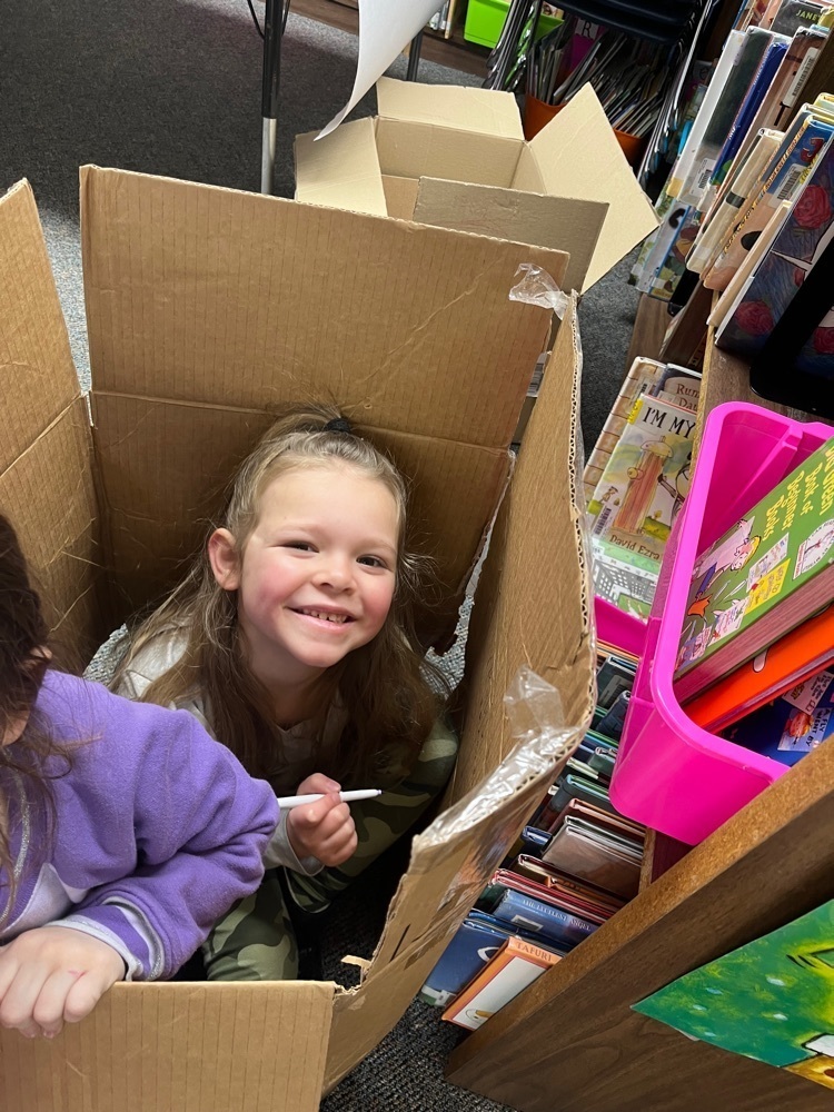 k student building with a box