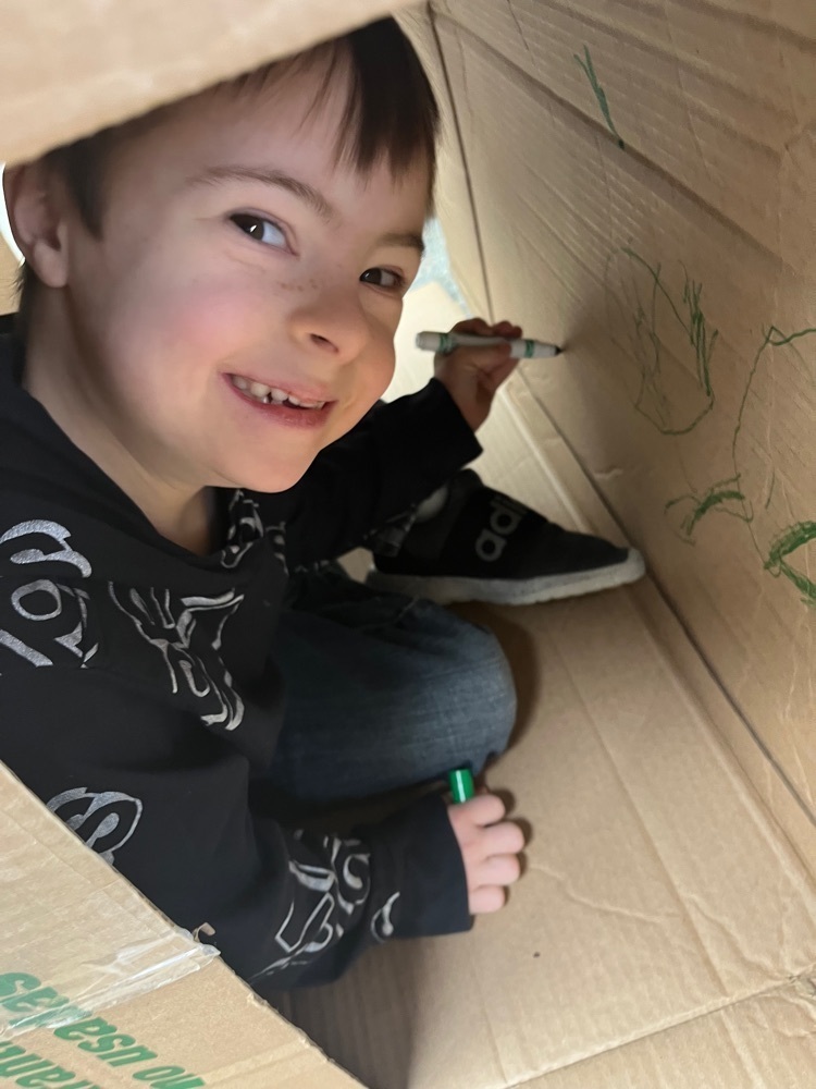 k student building with a box