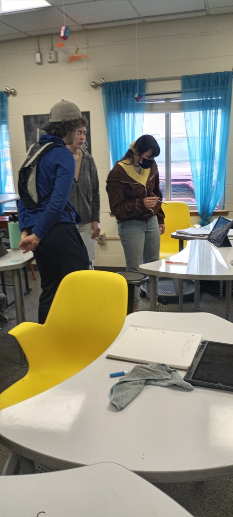 Students working on writing geometry transformation sentences