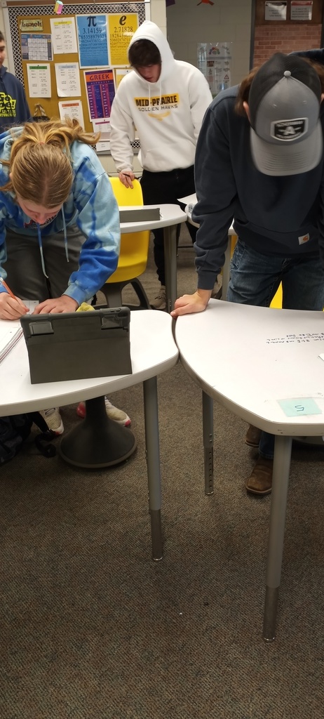 Students working on writing geometry transformation sentences