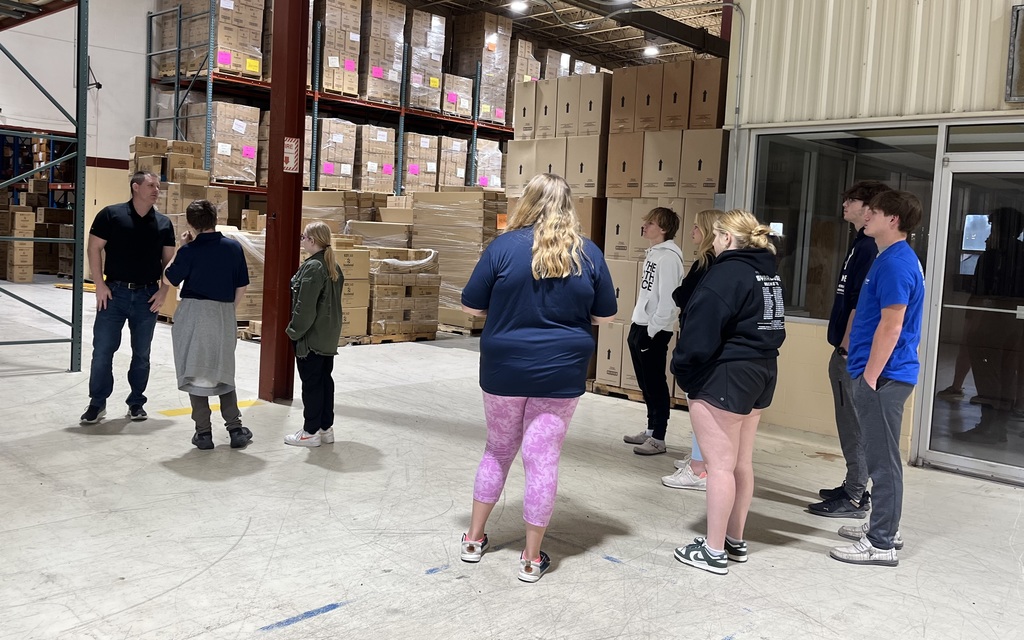 students standing in warehouse