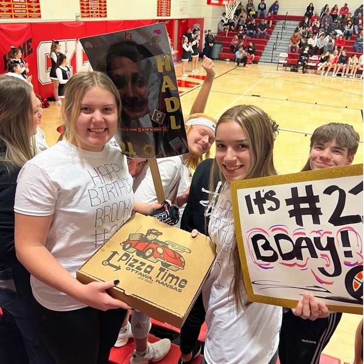 kids posing with pizza