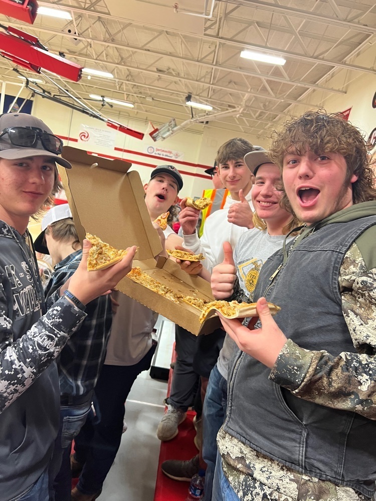posing with a pizza