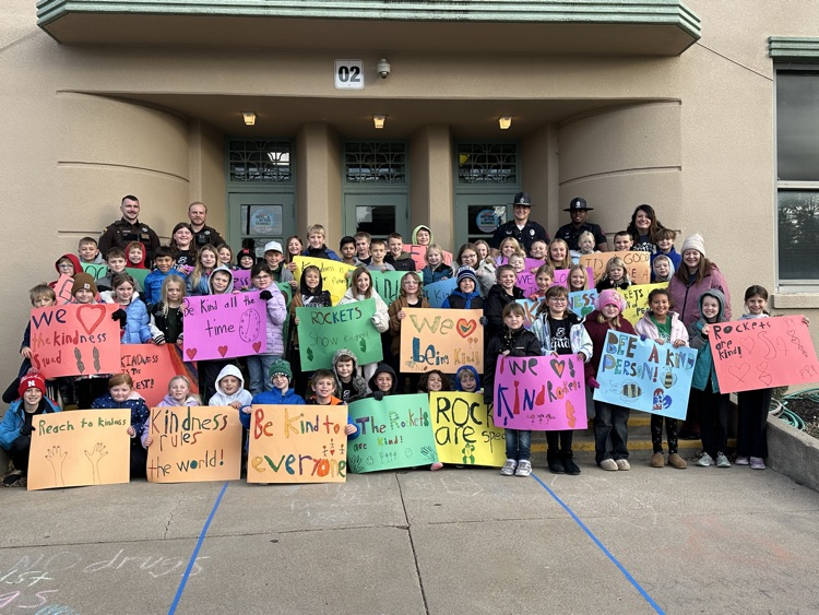 students holding posters