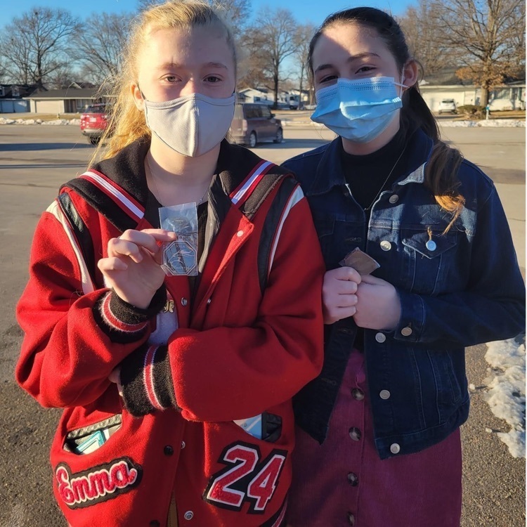 students posing with a medal
