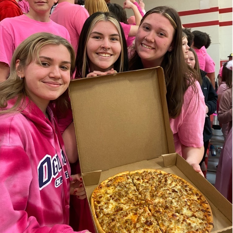students posing with a pizza