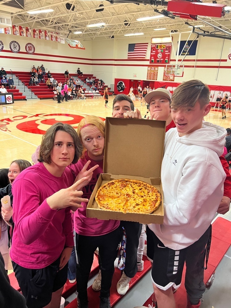 students posing with a pizza
