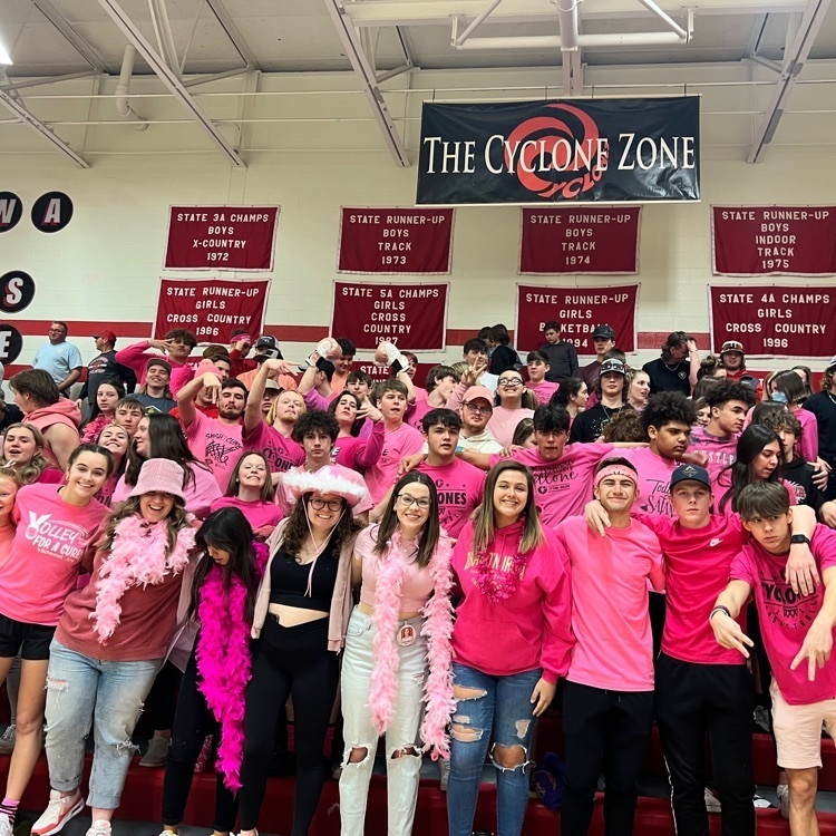 students posing in bleachers
