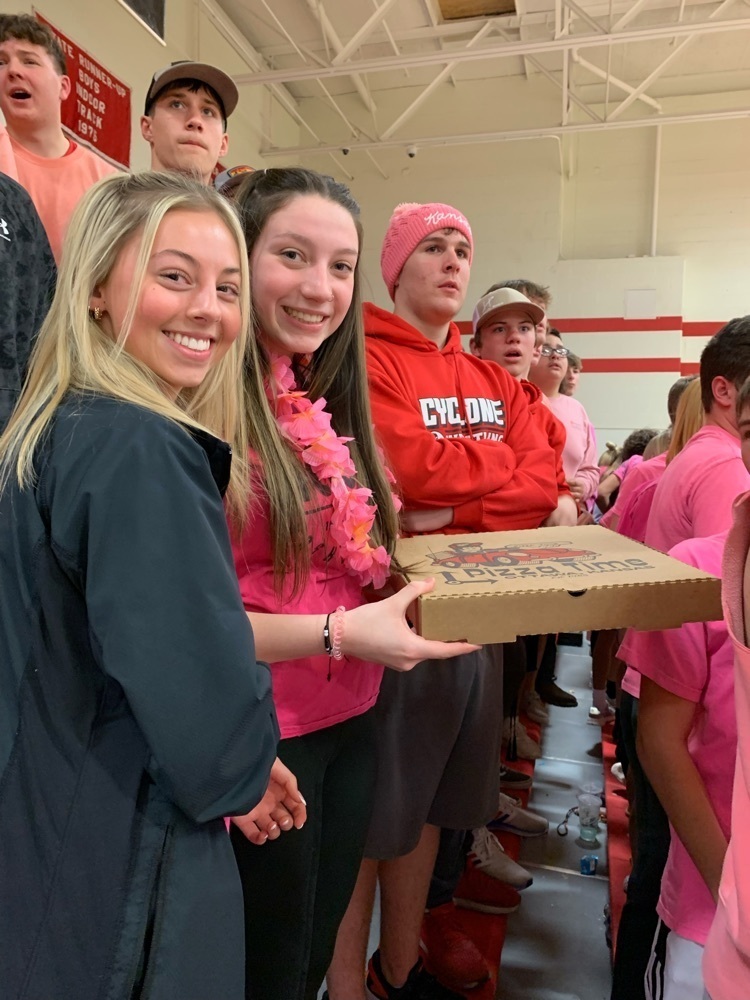 students standing with pizza