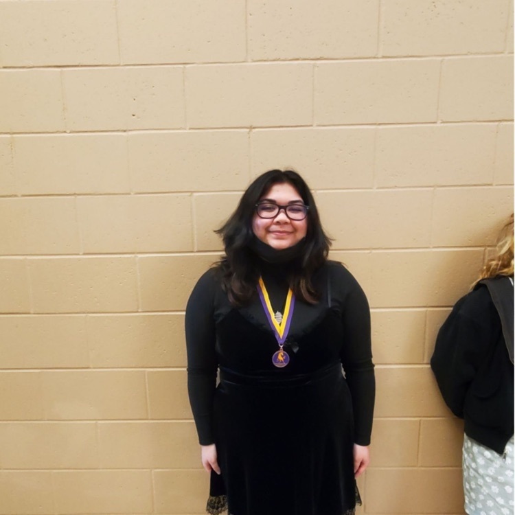 student posing with medals