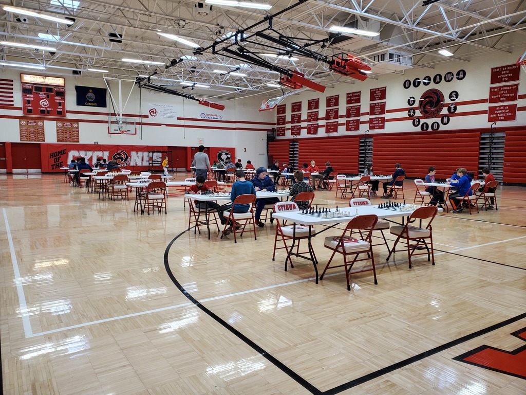 kids playing chess in a gym