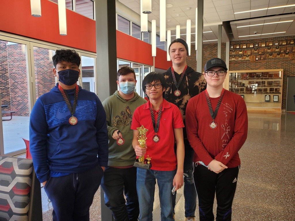 students posing  with a trophy