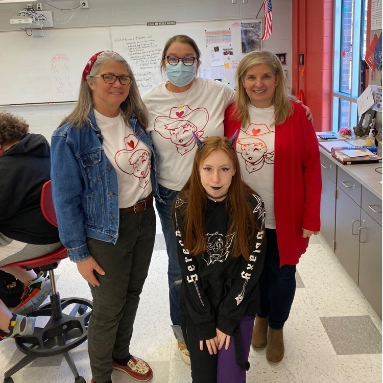 student posing with three adults