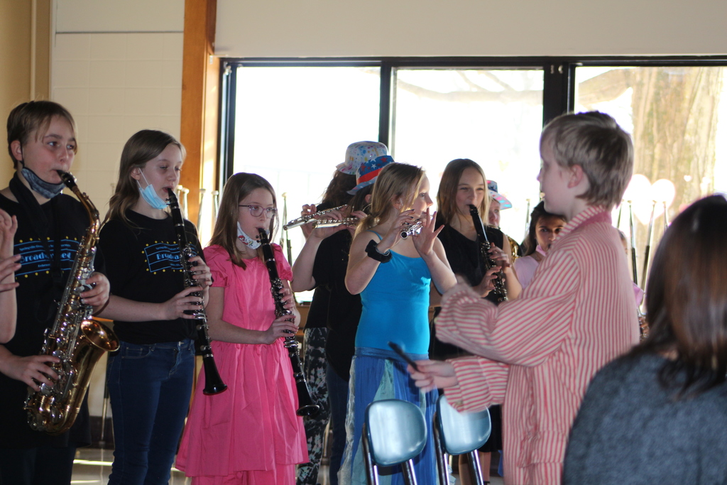 A student conducts students playing instruments