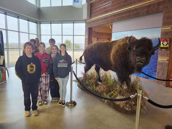 Students pictured by a buffalo at Battle of Washita.
