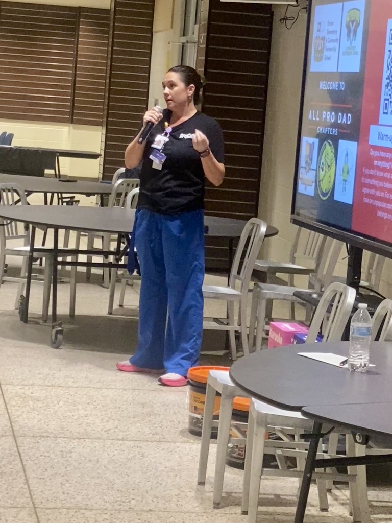 Nurse Amber talks to the fathers about the services available to them on their schools' campuses