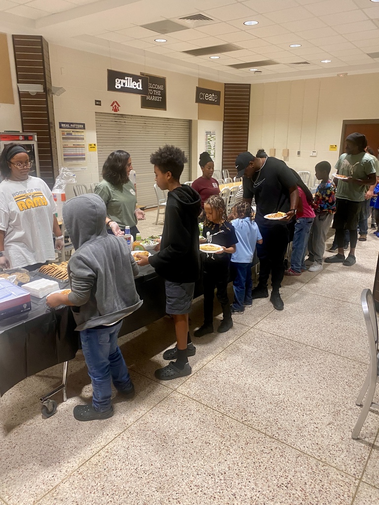 Dads and their children are served a dinner of delicious homemade spaghetti
