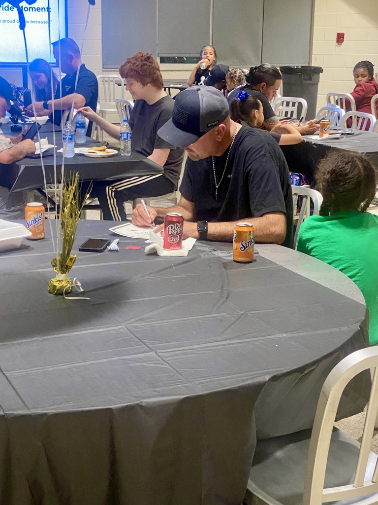 A father writes down how his child makes him proud on a special certificate