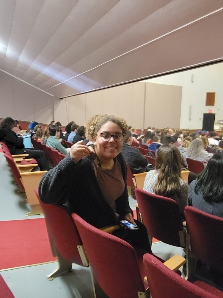 student posing with a medal 